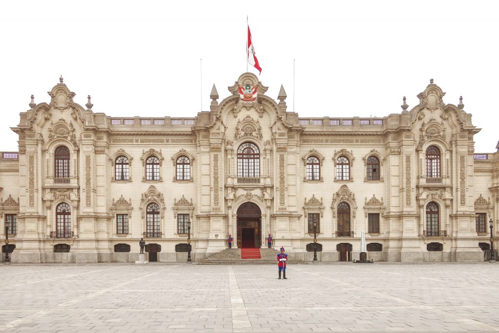LIMA PERU - OCTOBER 31 2011: Government palace with guards at Plaza de Armas in Lima Peru. It is the birthplace of the city of Lima as well as the core of the city. Located in the Historic Centre of Lima.