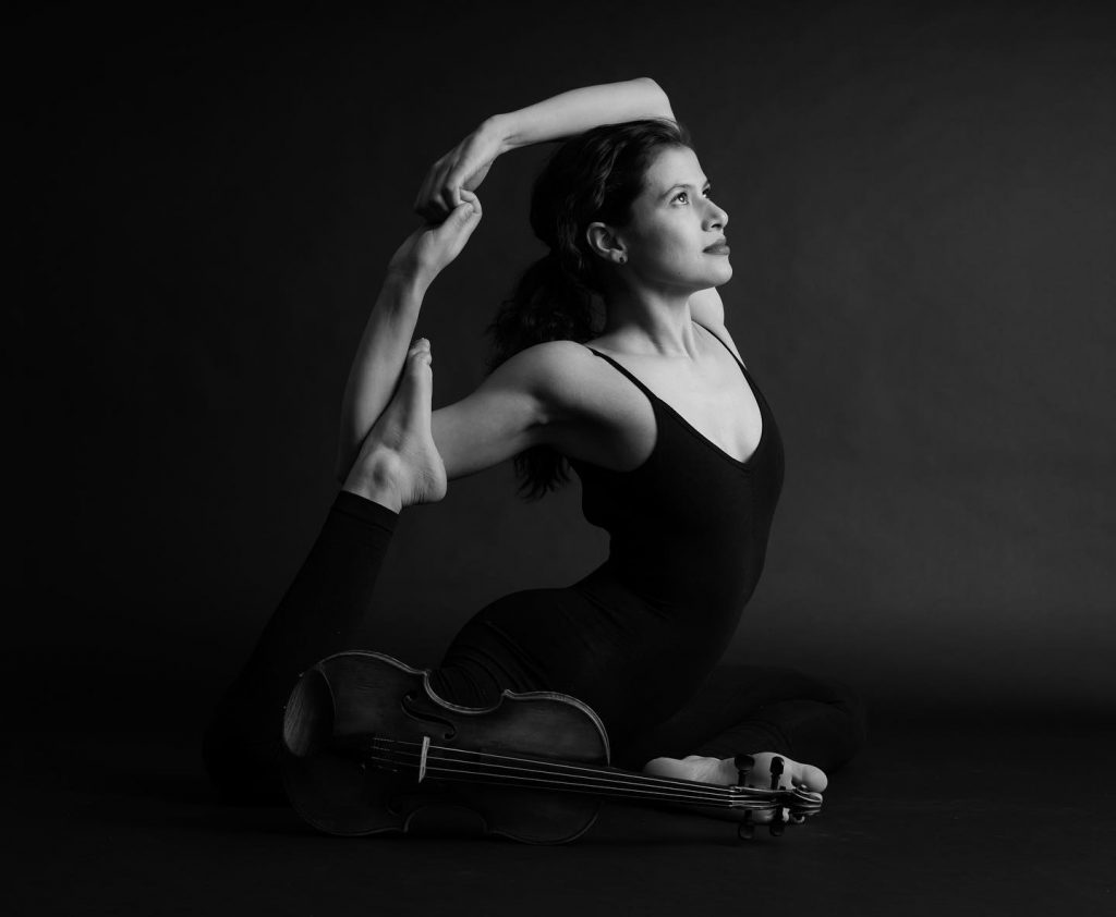 Elena practicing an advanced yoga pose